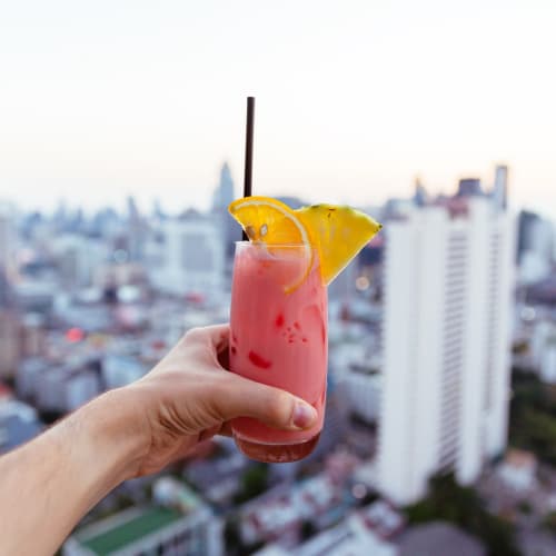 Resident raising a toast to the good life from the rooftop lounge at Legends at Pine Forest in Pensacola, Florida